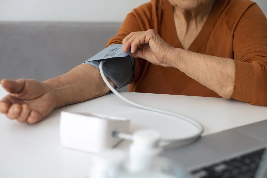 elderly person using a measuring blood pressure with a tensiometer